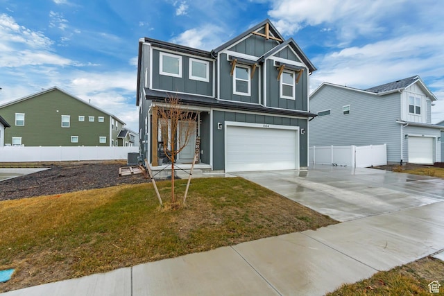 view of front facade with an attached garage, board and batten siding, fence, driveway, and a front lawn