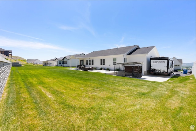 628 S 1080 E, Smithfield, UT 84335 - rear view of property featuring a jacuzzi, a patio area, a lawn, and a residential view