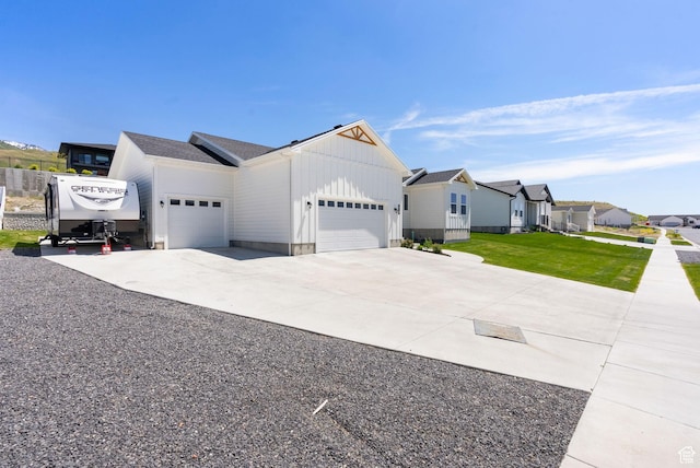 628 S 1080 E, Smithfield, UT 84335 - view of front of home featuring board and batten siding, an attached garage, concrete driveway, a residential view, and a front yard