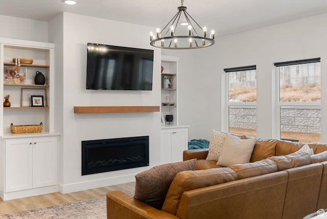 628 S 1080 E, Smithfield, UT 84335 - living room featuring a chandelier, light wood-type flooring, a fireplace, built in features, and recessed lighting