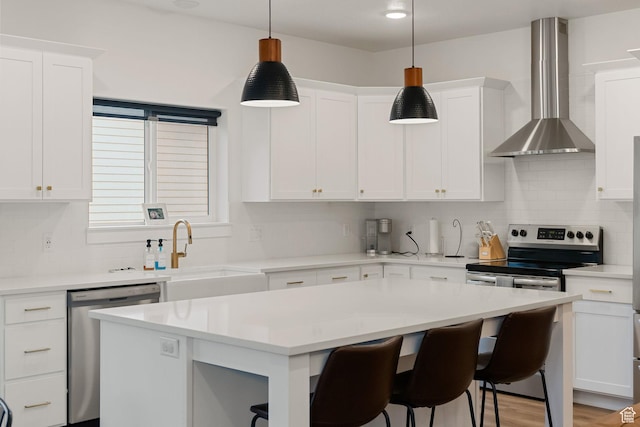 628 S 1080 E, Smithfield, UT 84335 - kitchen featuring stainless steel appliances, wall chimney range hood, light countertops, and decorative backsplash