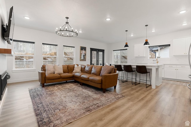 628 S 1080 E, Smithfield, UT 84335 - living area with recessed lighting, light wood-type flooring, a chandelier, and baseboards