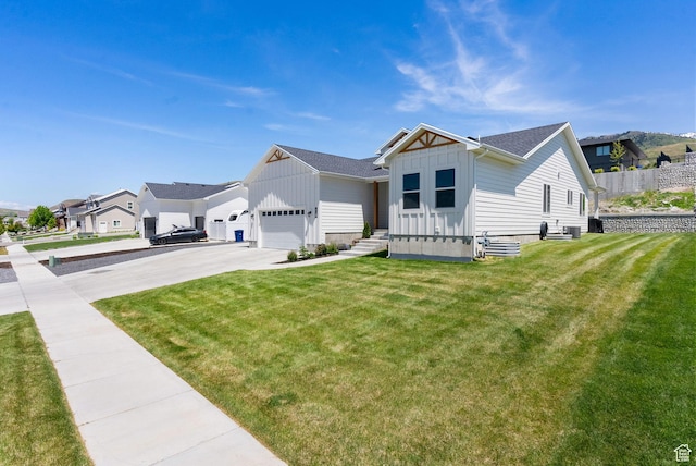 628 S 1080 E, Smithfield, UT 84335 - view of front of property featuring board and batten siding, driveway, a front lawn, a residential view, and an attached garage