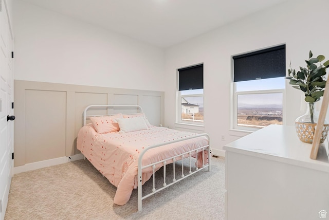 628 S 1080 E, Smithfield, UT 84335 - bedroom featuring light colored carpet, a wainscoted wall, and a decorative wall