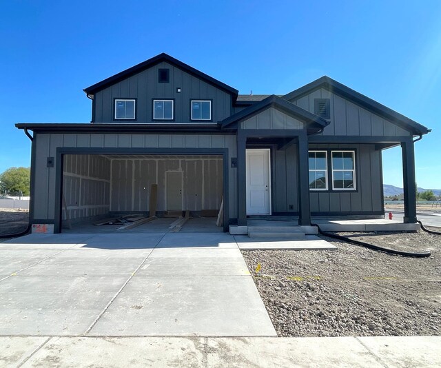 view of front of house with a garage, board and batten siding, and concrete driveway