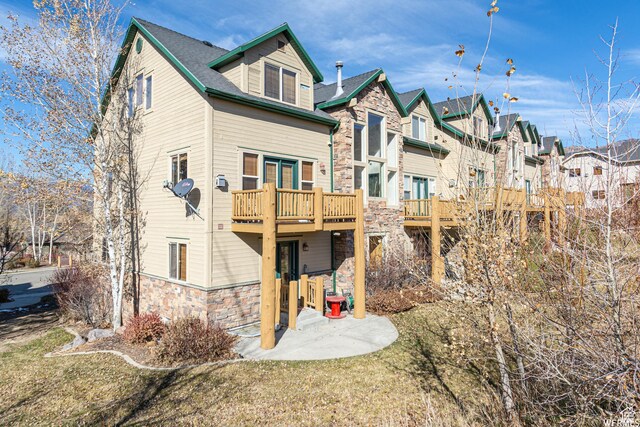 3612 N Huntsman Path Unit 603, Eden, UT 84310 - rear view of house with stone siding, a patio area, and a residential view