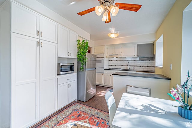 kitchen featuring a sink, white cabinetry, appliances with stainless steel finishes, and backsplash