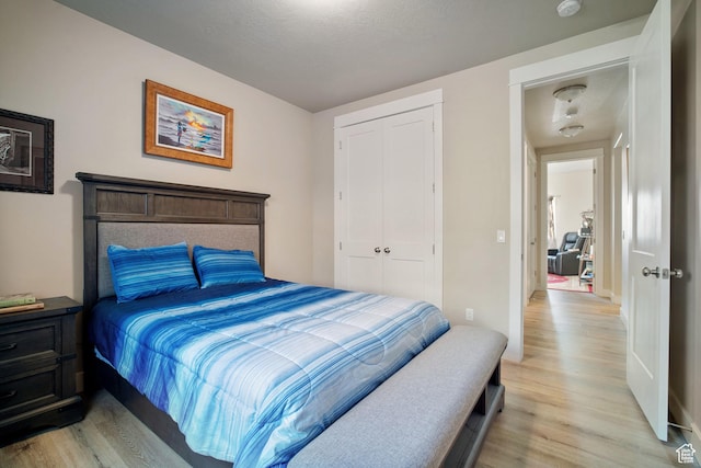24 S 900 E, Hyde Park, UT 84318 - bedroom featuring a textured ceiling, a closet, and light wood-style floors
