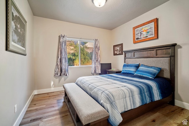 24 S 900 E, Hyde Park, UT 84318 - bedroom featuring a textured ceiling, light wood-style flooring, and baseboards