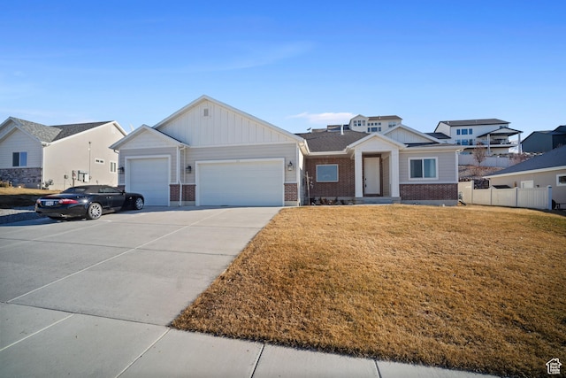 view of front of house featuring an attached garage, brick siding, fence, concrete driveway, and a front yard