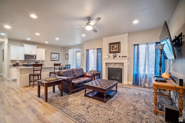 24 S 900 E, Hyde Park, UT 84318 - living area featuring a ceiling fan, recessed lighting, a stone fireplace, and light wood-style flooring