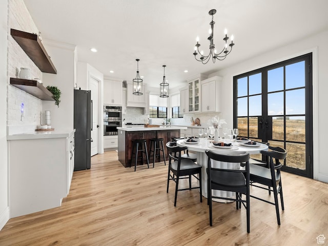 5351 S Lincoln Beach Rd, Spanish Fork, UT 84660 - dining room with light wood-style floors, recessed lighting, french doors, and an inviting chandelier