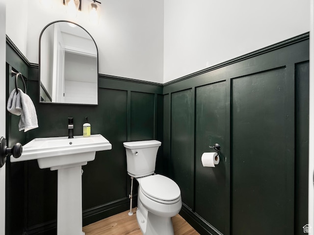 5351 S Lincoln Beach Rd, Spanish Fork, UT 84660 - half bathroom featuring toilet, a wainscoted wall, a decorative wall, and wood finished floors