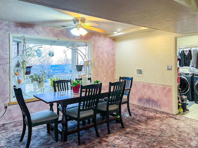 dining area featuring ceiling fan, a textured ceiling, washing machine and clothes dryer, and wallpapered walls