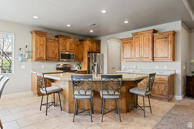 1921 W 390 N Street N, St. George, UT 84770 - kitchen featuring a breakfast bar, a center island with sink, recessed lighting, visible vents, and appliances with stainless steel finishes