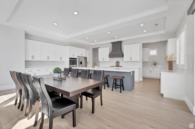 219 W Elinor Ln, Washington, UT 84780 - dining area with light wood finished floors, a tray ceiling, baseboards, and recessed lighting