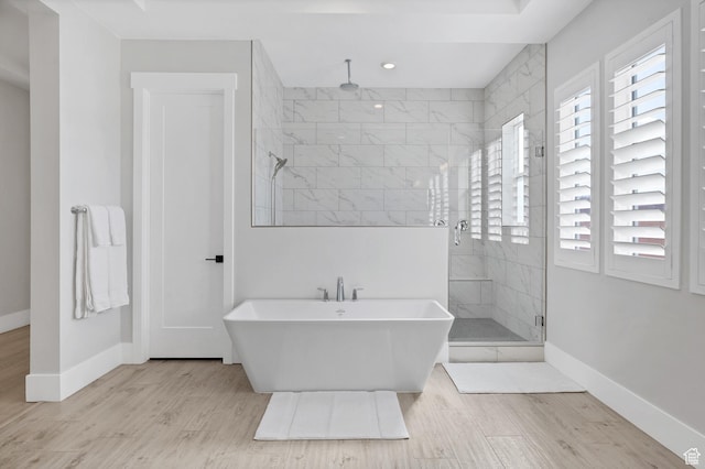 219 W Elinor Ln, Washington, UT 84780 - bathroom featuring a stall shower, a freestanding tub, baseboards, and wood finished floors
