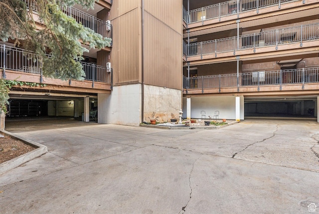 view of property featuring a garage and concrete driveway