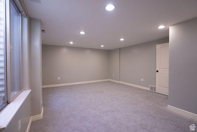 unfurnished room featuring baseboards, carpet, visible vents, and recessed lighting