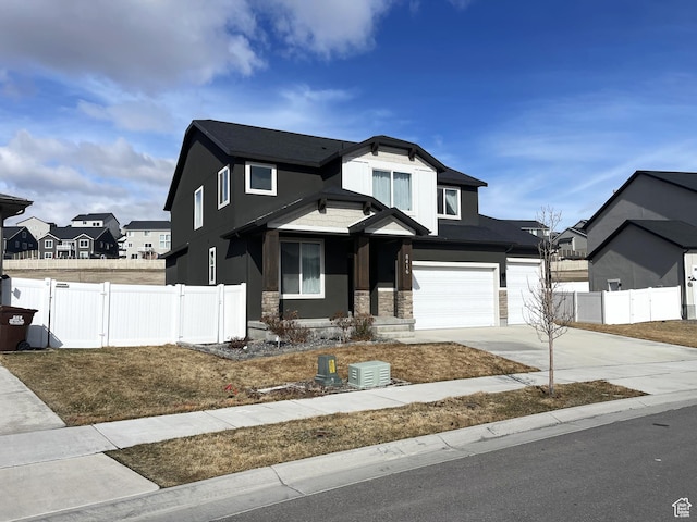 8416 N Sun Crest Dr, Eagle Mountain, UT 84005 - view of front of property with a garage, fence, driveway, stone siding, and a gate