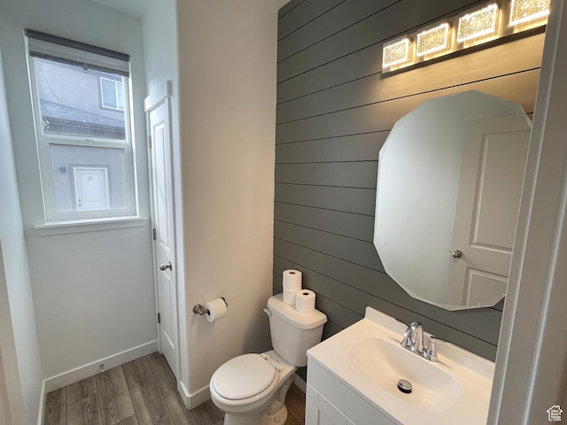 8416 N Sun Crest Dr, Eagle Mountain, UT 84005 - bathroom featuring wooden walls, baseboards, toilet, wood finished floors, and vanity