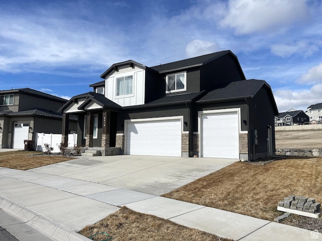 8416 N Sun Crest Dr, Eagle Mountain, UT 84005 - view of front of house with a garage, driveway, stone siding, board and batten siding, and stucco siding