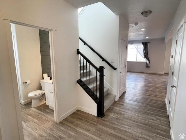 8416 N Sun Crest Dr, Eagle Mountain, UT 84005 - stairway with recessed lighting, wood finished floors, and baseboards