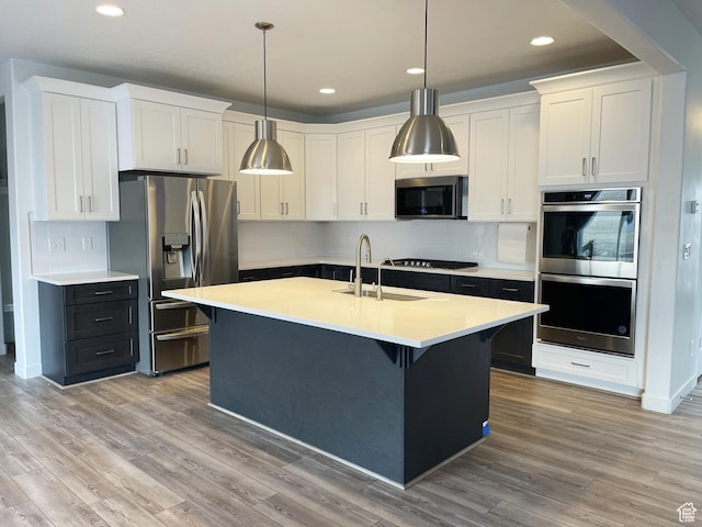 8416 N Sun Crest Dr, Eagle Mountain, UT 84005 - kitchen with stainless steel appliances, light wood finished floors, a sink, and light countertops
