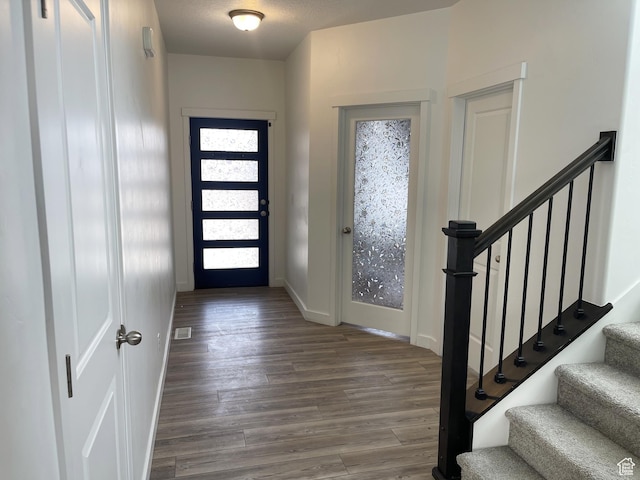 8416 N Sun Crest Dr, Eagle Mountain, UT 84005 - foyer entrance with stairs, visible vents, baseboards, and wood finished floors