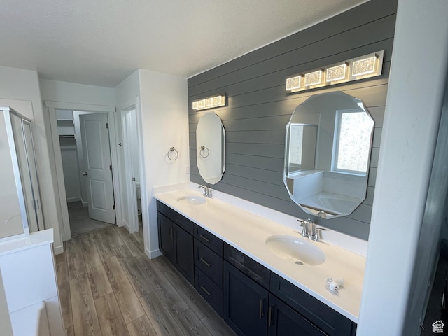 8416 N Sun Crest Dr, Eagle Mountain, UT 84005 - bathroom with double vanity, baseboards, a sink, and wood finished floors