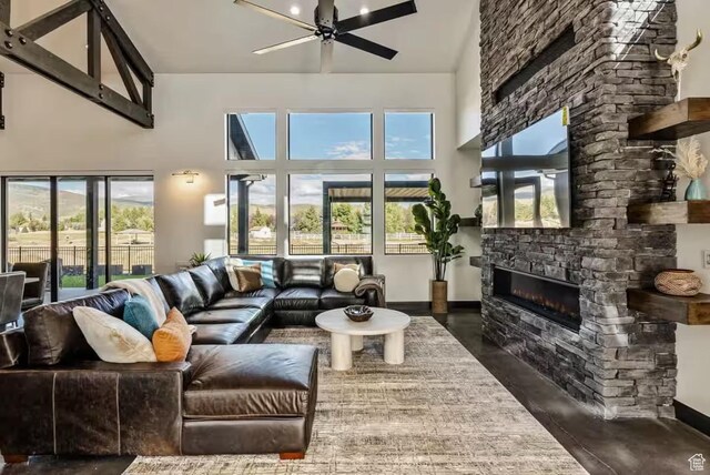 840 W Hilltop Ct, Francis, UT 84036 - living area featuring baseboards, a fireplace, a high ceiling, and ceiling fan
