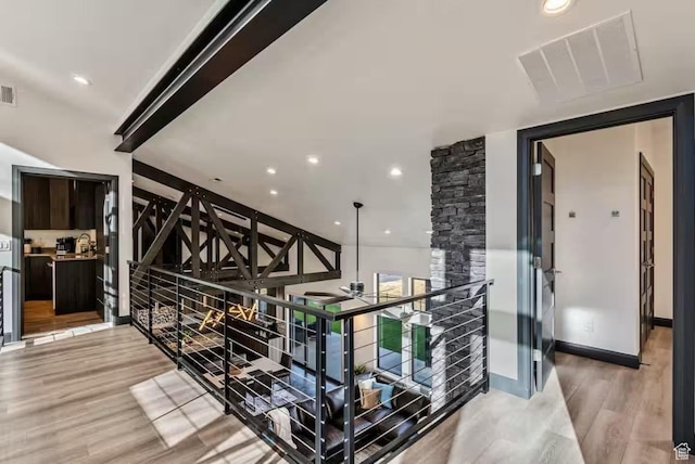 840 W Hilltop Ct, Francis, UT 84036 - corridor with light wood finished floors, visible vents, and an upstairs landing