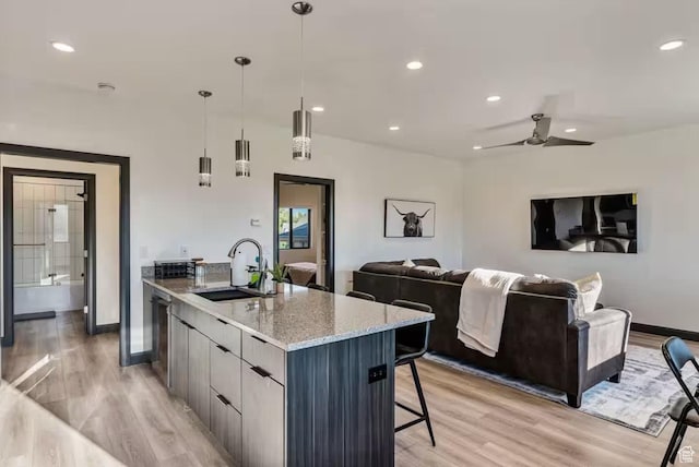 840 W Hilltop Ct, Francis, UT 84036 - kitchen with light wood finished floors, open floor plan, a sink, modern cabinets, and dishwasher