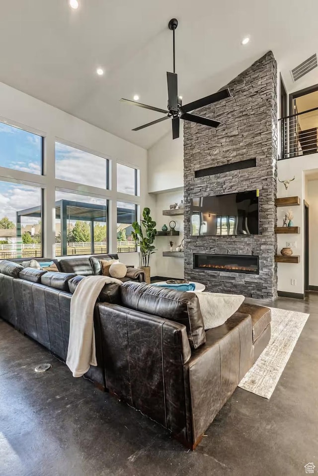 840 W Hilltop Ct, Francis, UT 84036 - living area with visible vents, ceiling fan, a stone fireplace, high vaulted ceiling, and concrete flooring