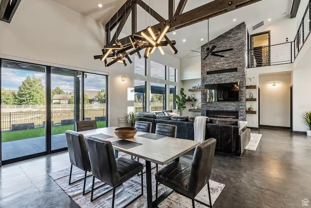 840 W Hilltop Ct, Francis, UT 84036 - dining area featuring concrete floors, high vaulted ceiling, beamed ceiling, and a stone fireplace