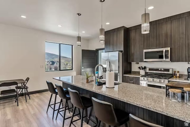 840 W Hilltop Ct, Francis, UT 84036 - kitchen with a sink, appliances with stainless steel finishes, modern cabinets, and a kitchen bar