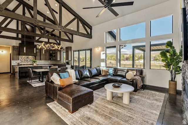 840 W Hilltop Ct, Francis, UT 84036 - living room with concrete flooring, high vaulted ceiling, a ceiling fan, baseboards, and beamed ceiling