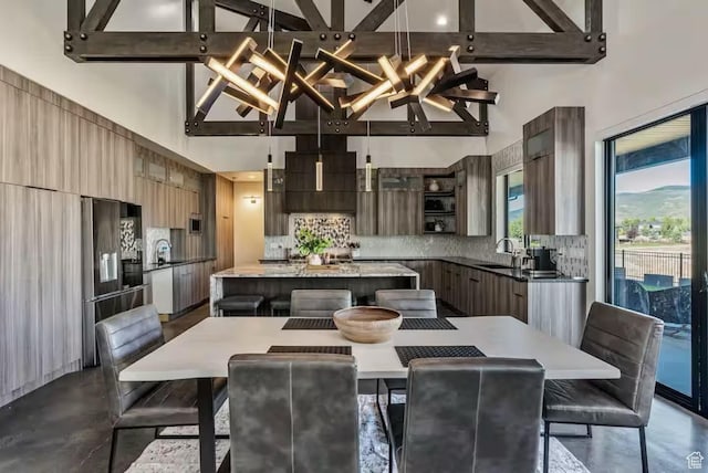 840 W Hilltop Ct, Francis, UT 84036 - dining space with concrete floors, beamed ceiling, and a towering ceiling