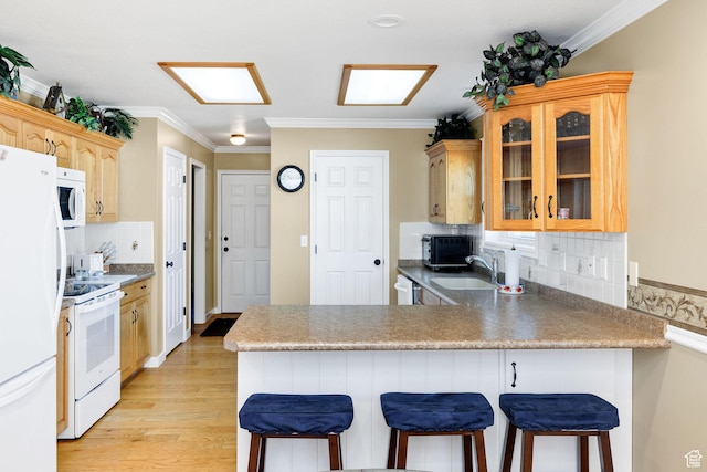 897 N 250 W, Logan, UT 84321 - kitchen with a sink, a kitchen breakfast bar, white appliances, crown molding, and glass insert cabinets