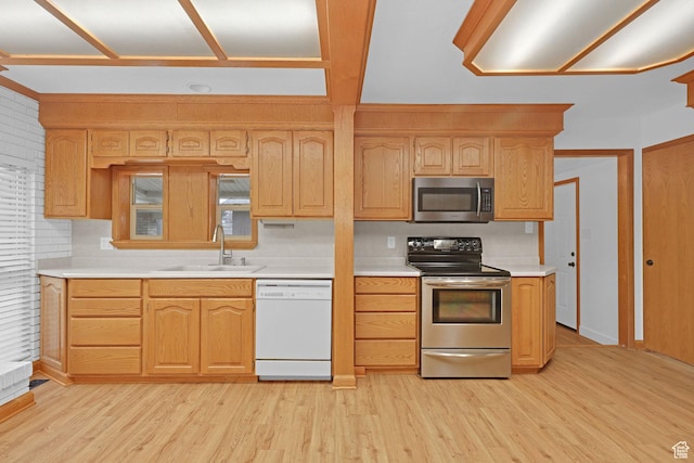 8693 S Vaquero Dr, Sandy, UT 84094 - kitchen featuring light countertops, light wood-type flooring, appliances with stainless steel finishes, and a sink