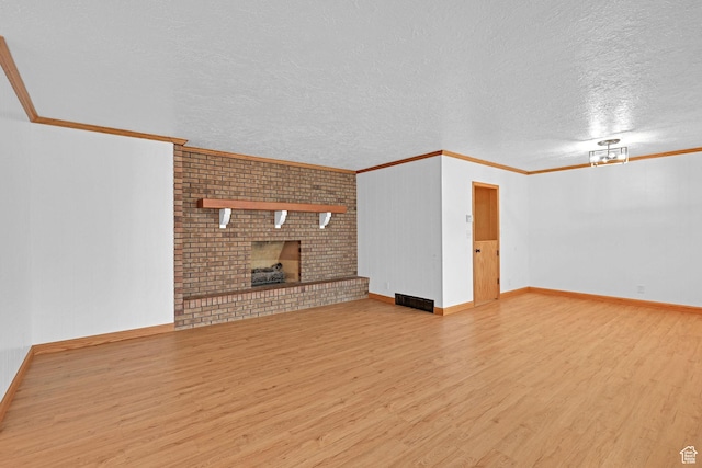 8693 S Vaquero Dr, Sandy, UT 84094 - unfurnished living room featuring a fireplace, crown molding, and wood finished floors