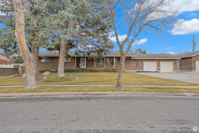 8693 S Vaquero Dr, Sandy, UT 84094 - ranch-style house with brick siding, a front lawn, fence, concrete driveway, and an attached garage