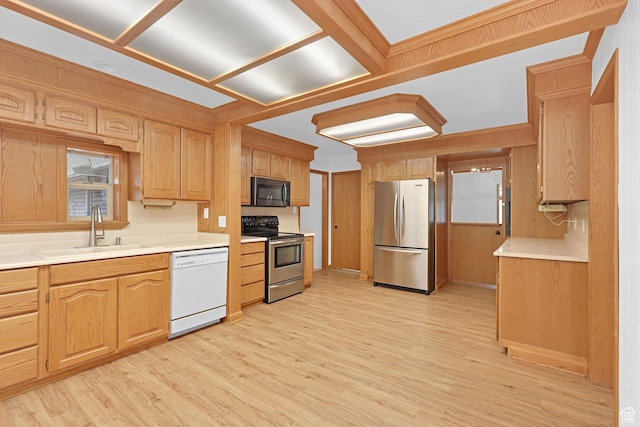 8693 S Vaquero Dr, Sandy, UT 84094 - kitchen with light wood-style flooring, appliances with stainless steel finishes, light countertops, and a sink