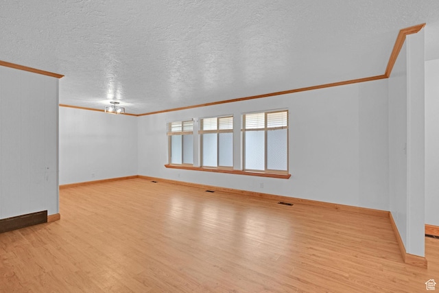 8693 S Vaquero Dr, Sandy, UT 84094 - empty room featuring visible vents, a textured ceiling, crown molding, and light wood finished floors