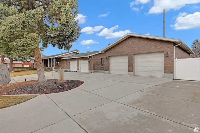 8693 S Vaquero Dr, Sandy, UT 84094 - ranch-style house featuring a garage, fence, brick siding, and driveway