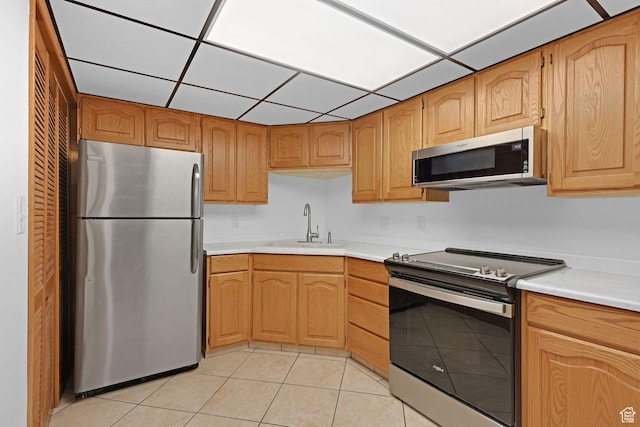 8693 S Vaquero Dr, Sandy, UT 84094 - kitchen with light tile patterned floors, appliances with stainless steel finishes, light countertops, and a sink