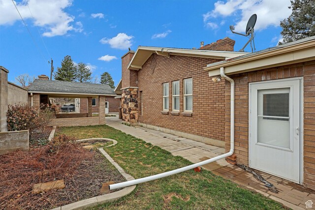 8693 S Vaquero Dr, Sandy, UT 84094 - view of property exterior featuring brick siding and a chimney