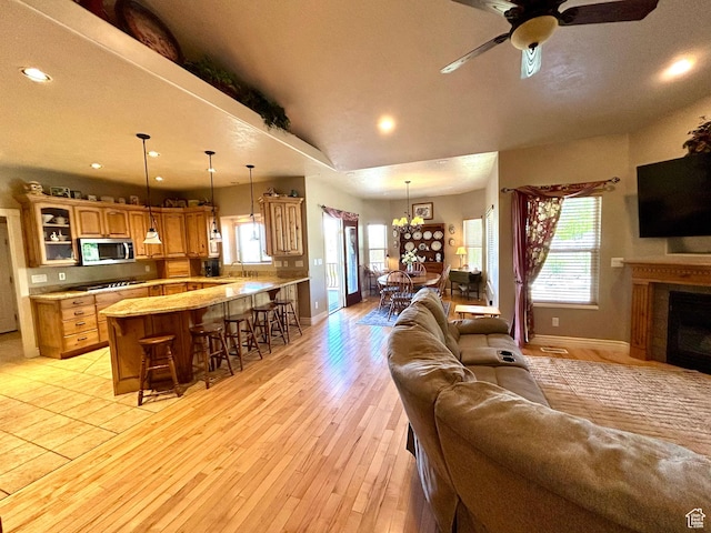 9575 Aztec Dr, Cedar Hills, UT 84062 - living area with recessed lighting, baseboards, light wood-style flooring, and ceiling fan with notable chandelier