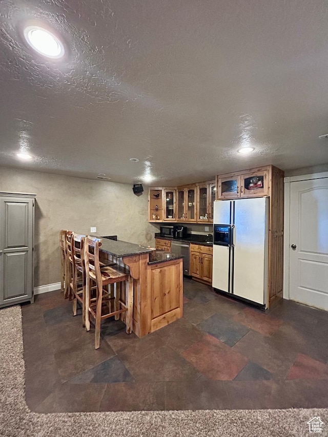 9575 Aztec Dr, Cedar Hills, UT 84062 - kitchen featuring dark countertops, glass insert cabinets, a kitchen bar, dishwasher, and white fridge with ice dispenser