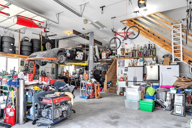9575 Aztec Dr, Cedar Hills, UT 84062 - garage featuring a garage door opener and a workshop area
